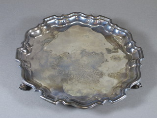 A silver salver with bracketed border, raised on 3 scroll feet Sheffield 1966, 15 ozs