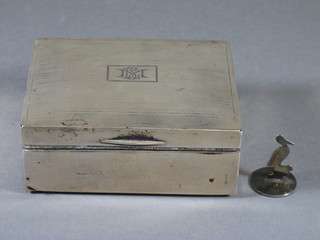 A rectangular silver cigarette box with engine turned decoration,  marks rubbed, containing a white metal menu holder in the form  of a stork
