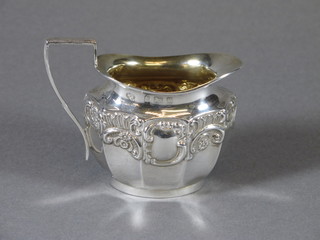 An Edwardian oval embossed silver cream jug, Birmingham  1904, 2 ozs