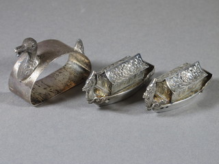 A sterling silver napkin ring in the form of a duck and 2 Eastern white metal pepperettes in the form of barges