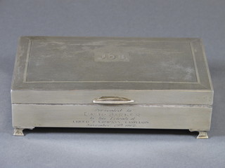 A rectangular silver cigarette box with engine turned decoration on bracket feet, 6", Birmingham 1961