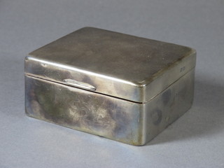 A silver cigarette box with engine turned decoration and hinged lid, Birmingham 1921 4"