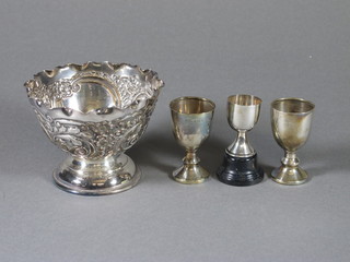 An embossed white metal bowl and 3 silver goblet shaped trophy  cups, 4 ozs