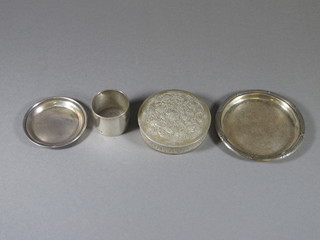 A silver napkin ring London 1923 by the Goldsmiths & Silversmiths Co. 2 small dishes 4" and 3" and an Eastern white  metal jar and cover, 7 ozs