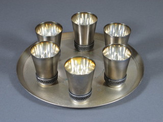 A Soviet Russian 7 piece silver plated vodka set comprising 7.5" circular salver and 6 shot glasses, marked 910mmet