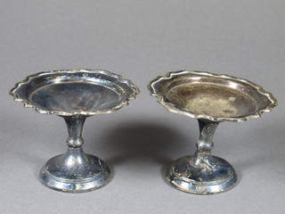 A pair of circular white metal comports 2.5"