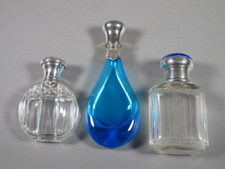 A glass scent bottle with silver and blue enamelled lid, some chips to enamel, Birmingham 1927 3.5", a circular cut glass  scent bottle with silver lid 1" and a blue club shaped scent bottle  3.5"