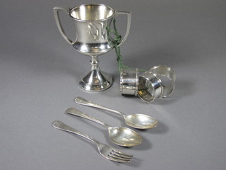 A silver twin handled trophy cup, Birmingham 1924, 3 silver  napkin rings and a childs 3 piece christening set comprising  knife, fork and spoon, 7 ozs