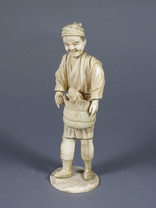 A Meji period Japanese carved ivory okimono of a standing  gentleman with basket with rabbit 8"