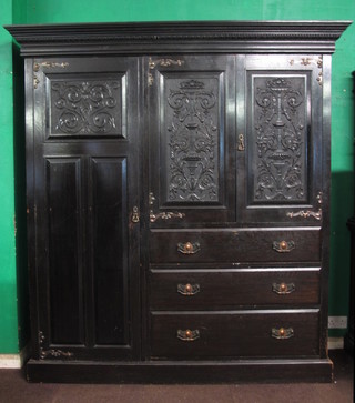 A late 19th Century oak wardrobe with egg and dart moulded  cornice above a pair of doors, inset relief carved panels in the  renaissance taste flanked by a further panelled cupboard door and  above 3 long drawers, raised on plinth base 84"h x 79"w x 24"d