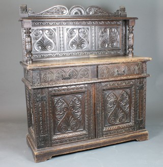 A Victorian carved oak sideboard, the raised back with carved  panels supported by a pair of bulbous turned columns, the base  fitted 2 long drawers above 2 panelled doors, raised on a  platform base 57"h x 50"w x 18.5"d