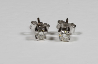 A pair of diamond claw set ear studs, approx 0.36ct
