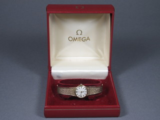 Omega, Geneva, a 1960's 9ct yellow gold lady's cocktail watch  having champagne baton dial, with original box