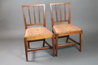 A set of 4 George III beech wood dining chairs with upholstered  drop in seats, raised on square tapering supports