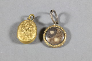 A 19th Century circular gilt metal mourning locket and a gilt  metal locket