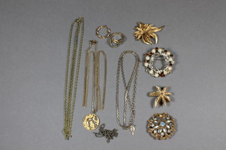 A collection of various costume jewellery including brooches, earring, dress ring, and chains 