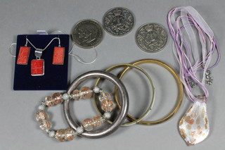 A rectangular hardstone pendant hung on a silver chain with  matching earrings, a silver bangle and other bangles, 3  commemorative crowns, etc