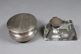 A silver dressing table jar with hinged lid, raised on bun feet Birmingham 1922, 2.5" and an Edwardian cut glass and silver  mounted inkwell 1907 3.5"