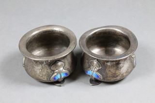 A pair of Art Nouveau circular silver and enamelled salts, raised on 3 spade feet, Birmingham 1905 decorated blue enamel