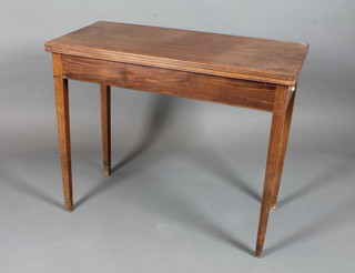 A George III mahogany folding top tea table, raised on square tapered collared legs 29"h x 35.5"w x 17"d