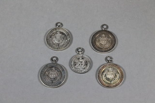 A silver sporting medallion and 4 others