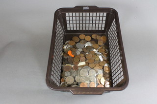 A brown crate containing a collection of coins
