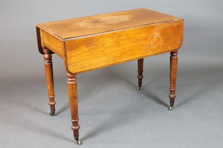 A Victorian mahogany Pembroke table fitted a drawer, raised on turned supports ending in brass caps and casters 28"h x 36"w x  18.5"d