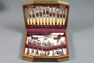 A canteen of chromium plated Old English pattern cutlery in an oak canteen box
