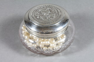 A circular cut glass dressing table jar with silver lid decorated the Arms of The Worshipful Company of Joiners and Cellarers,  Birmingham 1934 - glass cracked and a string of pearls