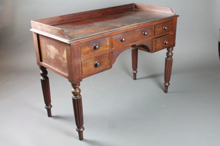 A William IV mahogany dressing table with three-quarter gallery fitted 1 long and 4 short drawers, raised on turned and reeded  supports 31"h x 44"w x 20"d
