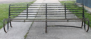 A Victorian style wrought iron 4 seat garden bench, distressed
