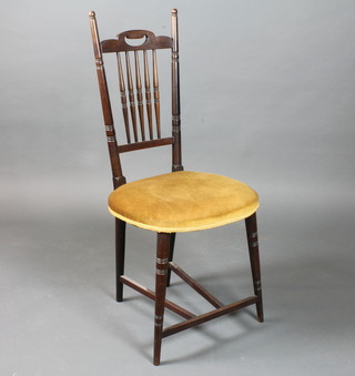 An English Art Nouveau mahogany salon chair, having turned  spindle back, stuff over seat, raised on ring turned tapered legs  united by stretchers