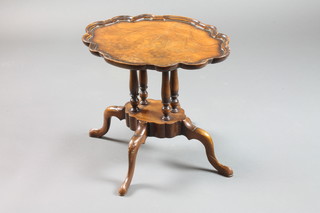 A Chippendale style oval walnut wine table with pie crust edge  raised on 4 turned columns with platform base, raised on a  further 4 scrolled supports 18"h x 20"w x 16"d