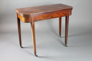 A George IV mahogany D shaped folding top tea table on square tapering legs, brass caps and casters 29"h x 36"w x 18"d