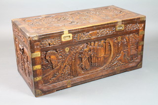 A carved camphor wood coffer with hinged lid and brass banding  20"h x 41"w x 20"d