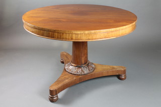 A Victorian circular tilt top breakfast table raised on a turned column, bun feet 32"h x 42"diam.