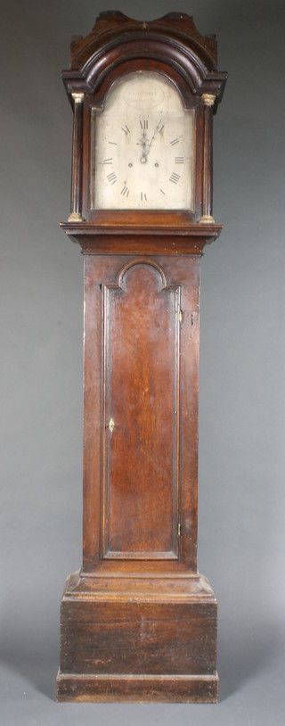 Edward Box of Chichester, a late George III oak longcase clock,  having a 12" broken arch Arabic and Roman silvered dial, set  second subsidiary dial within foliate engraved spandrels, set an 8  day two train movement, lacking bell. The case with broken  arched hood above a shaped and moulded trunk door, plinth base  84"h x 20"w