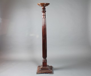 A Victorian style turned mahogany torchere with reeded column  support, stepped plinth base, 58"h