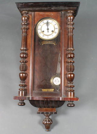 A 19th Century walnut Vienna wall regulator, having a Roman enamelled dial, 8 day movement. The case with turned split  pilasters, 31"h x 15"w