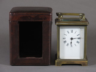An early 20th Century French brass carriage timepiece with  corniche case and Roman enamelled dial, complete with a red  leather travelling case 5"h x 3.5"w