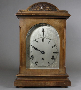 An Edwardian walnut mantel clock of architectural form having  foliate engraved Roman silvered dial with chime/silent subsidiary  dial, set 8 day movement chiming gongs, 17"h x 11"w