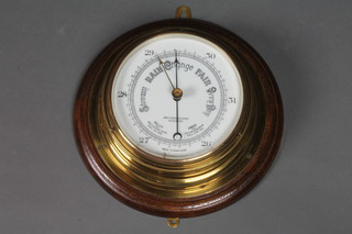 John Barker & Co. Kensington London, a late Victorian binnacle aneroid barometer on an oak mount, 11" diam.
