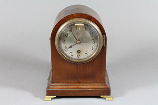 An Edwardian mahogany mantel timepiece, the arched case set a silvered dial with 8 day cylinder movement, bears label to inside  of door, Clock Maker L W Nichol, Scarborough, raised on brass   bracket feet 8"h x 6.5"w