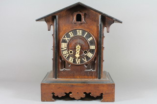 A late 19th Century Bavarian Black Forest carved oak cuckoo clock, having Arabic dial, raised on shaped plinth base 16.5"h x  14"w