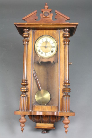 A late 19th Century stained beech and walnut Vienna wall  regulator, the case of architectural form set Roman painted dial  with 8 day movement 33"h x 16"w