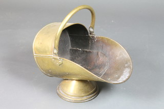 A brass helmet shaped coal scuttle