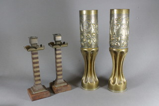 A pair of Continental Trench Art vases converted from shell cases marked Ypres and Somme and a pair of brass and bakelite  candlesticks 10"