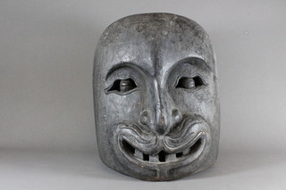 An Eastern carved wooden mask 13"