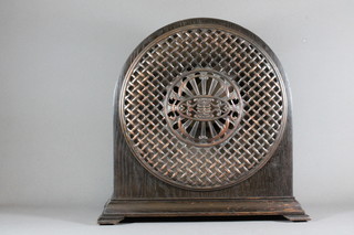 A Radiolux radio speaker contained in an arched oak case raised  on bracket feet 16"