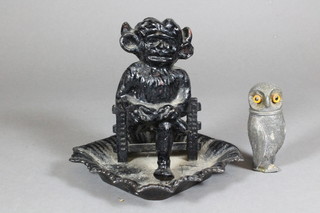 A pewter pepperette in the form of an owl set hardstone eyes 3"  and a cast iron inkwell? in the form of a seated imp 5"